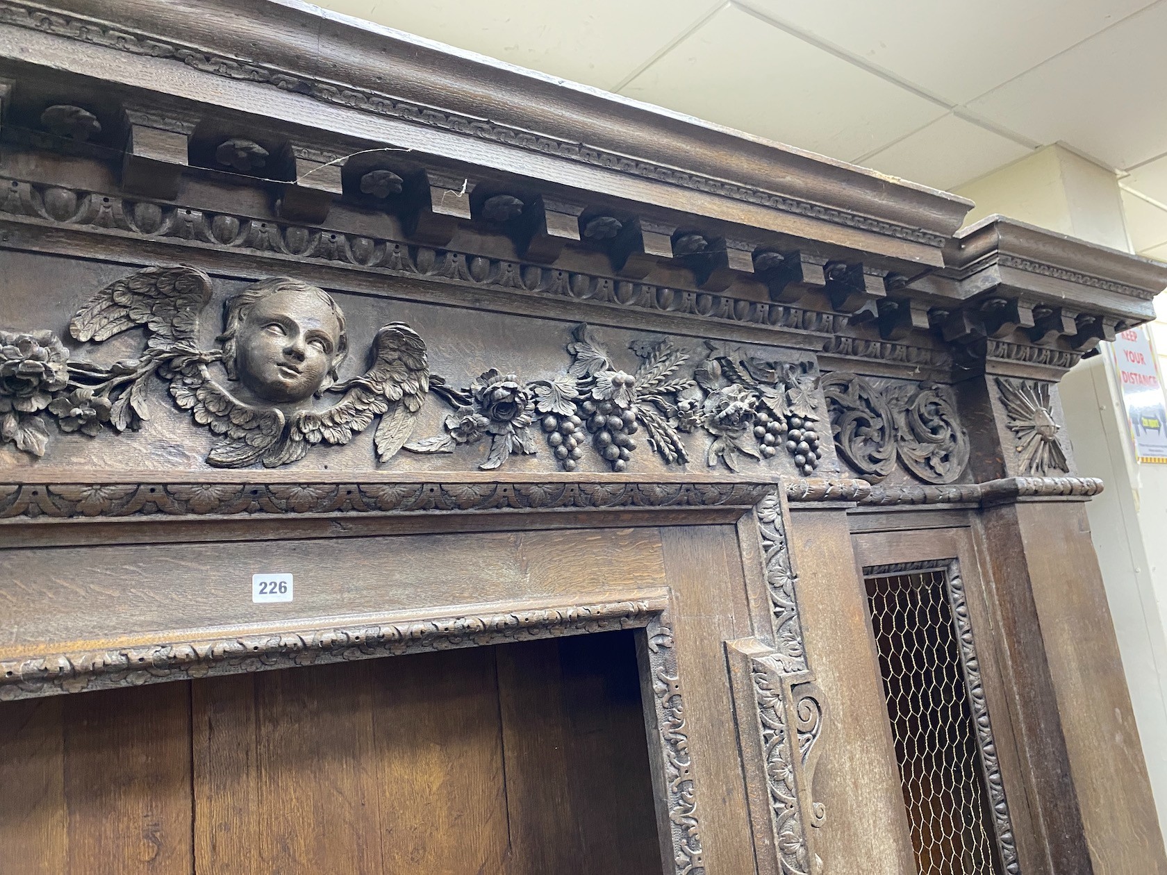 A large 19th century oak breakfront cabinet, with a finely carved frieze, length 280cm, depth 47cm, height 227cm